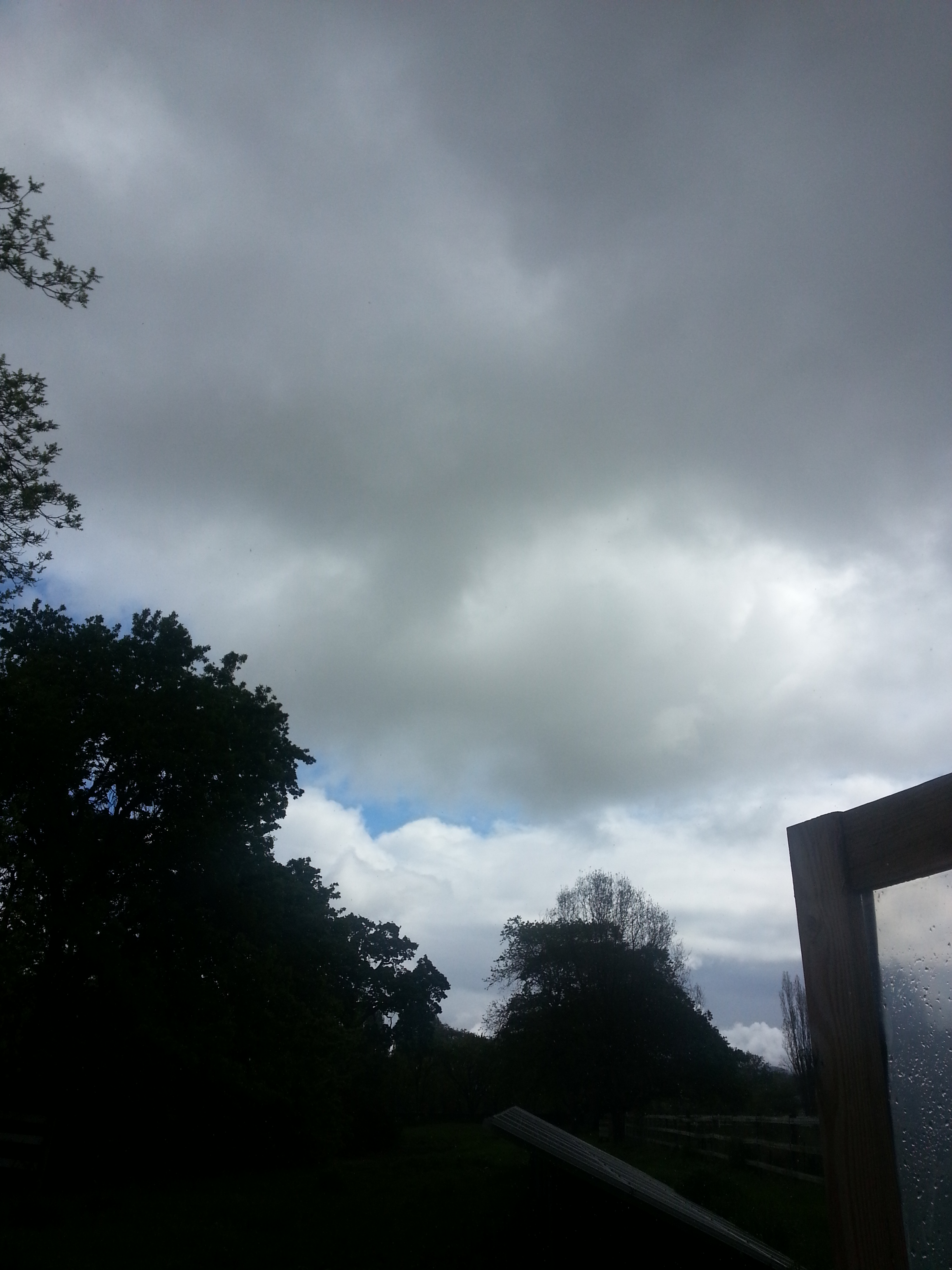 Dark storm clouds outside of the greenhouse